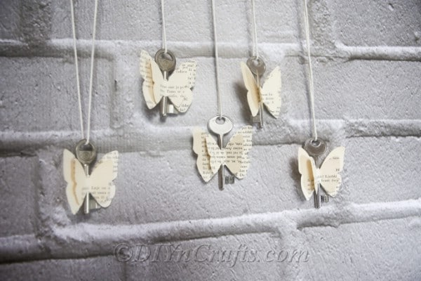 Rustic old book butterflies are lovely displayed against a wall.