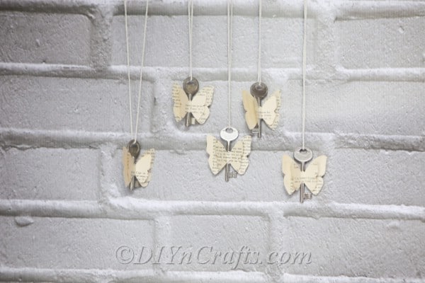 Old book butterflies are displayed against a wall.