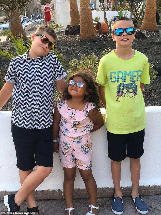 The mother-of-three shared her worries about her daughter Flossy getting the same opportunities as her older brothers. Pictured, siblings Flossy, four, who is black - and Fin, 11, and Maxwell, eight, who are white