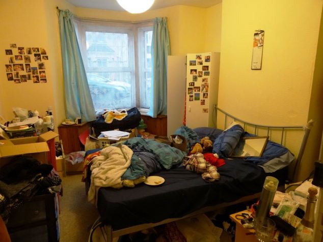 With a mirror on the pillow, a plate on the bed, another under papers on the desk, this room