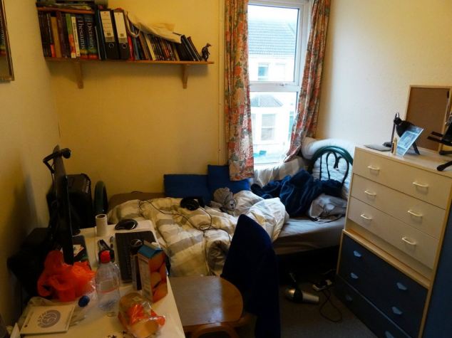 One of the tidier shots, this bed is tangled with wires, with an assorted food and plastic bags on the desk