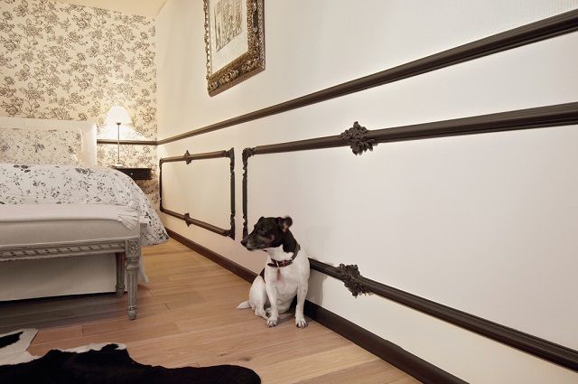 Несмотря на то что отделка стены сверху донизу выполнена в одном цвете, молдинг разделяет поверхность на верхнюю и панельную области