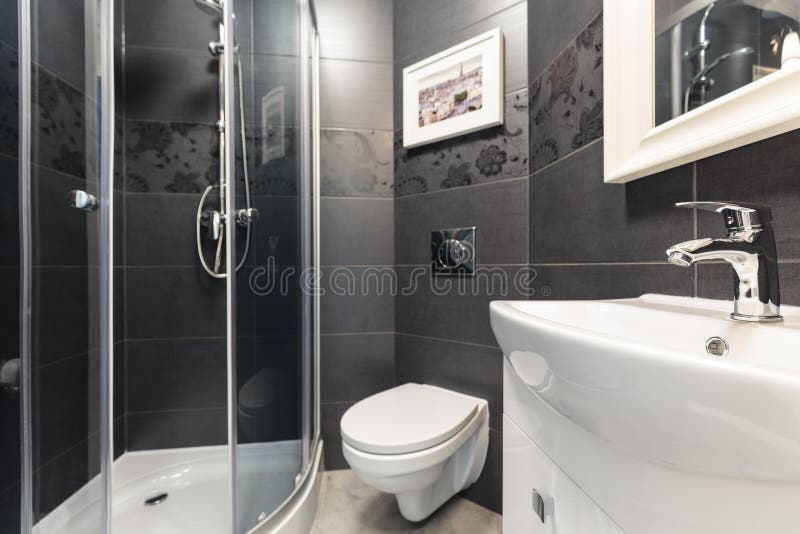 Black tiles in contemporary toilet. Black tiles on the wall in contemporary toilet royalty free stock photos