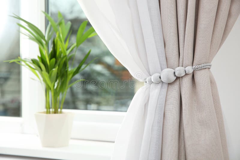 Draped window curtains with tieback in room, space for text royalty free stock photography