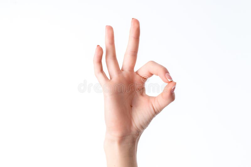 Female hand showing the gesture from contacting each other index finger and thumb is isolated on a white background royalty free stock photography