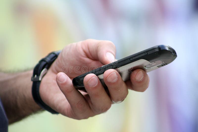 Mobile phone in mans hand royalty free stock image