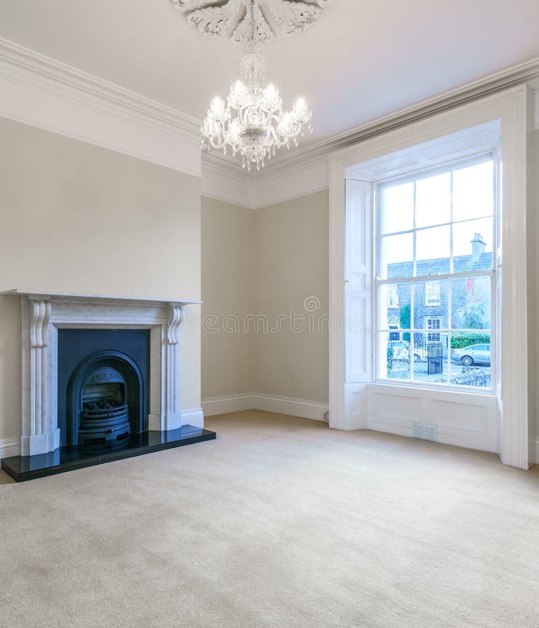 Nice spacious living room with a large window and stylish fireplace stock image