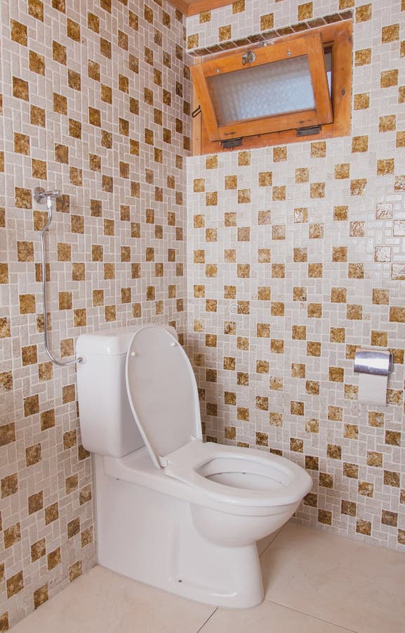 Old clean toilet with old tiles. (80s stock photo