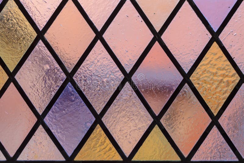 Stained glass with multi colored diamond pattern as background royalty free stock photos