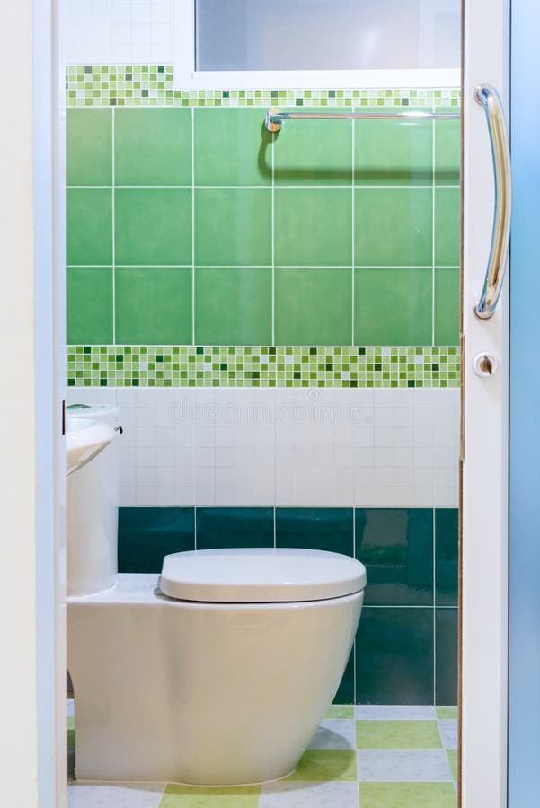 Toilet with green tile view. From outside stock images