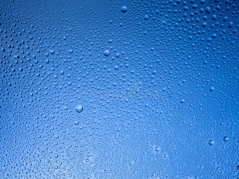 Water droplets on the glass with a colored background. stock photo